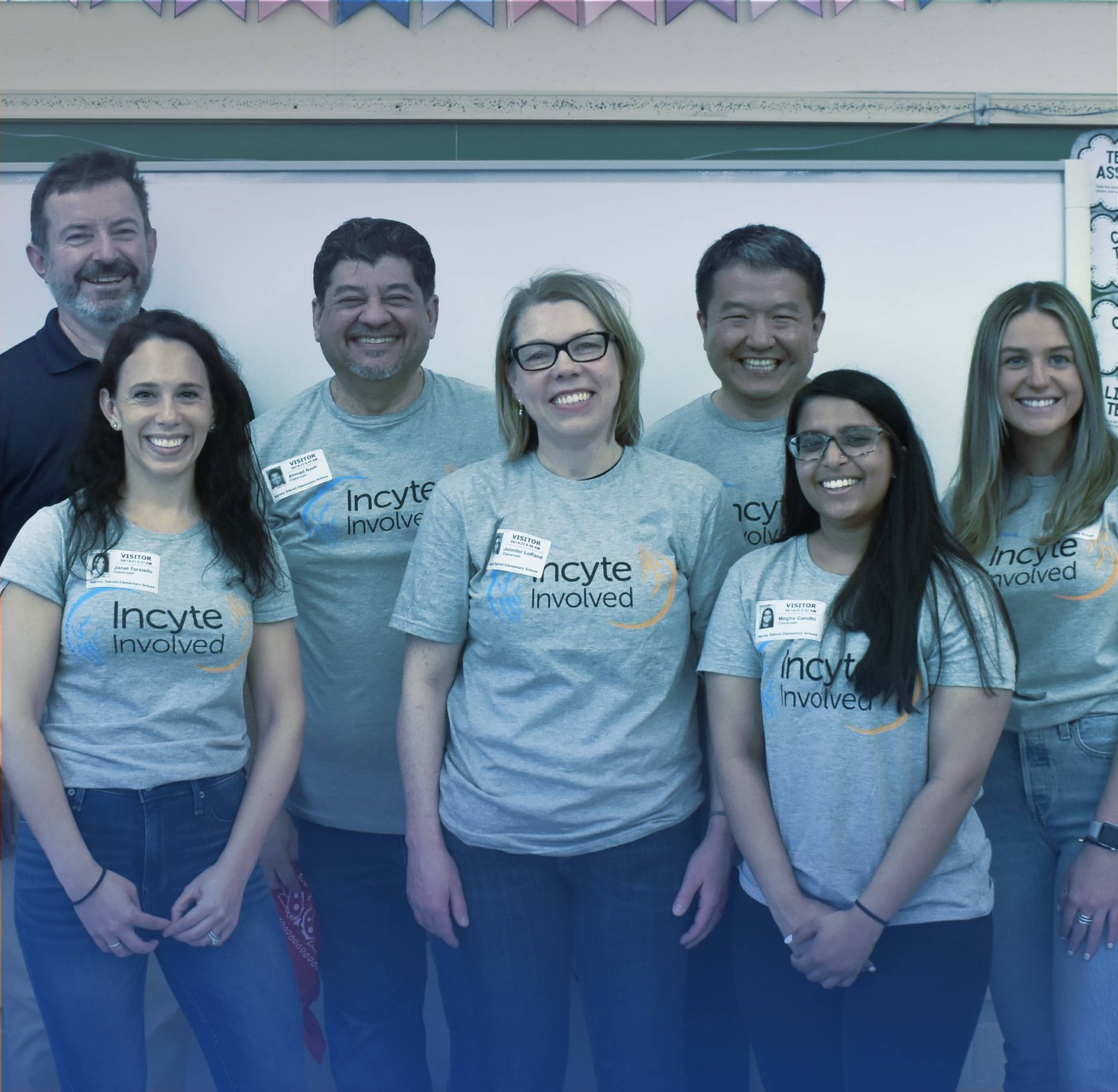 Large group of people standing in front of a chalkboard