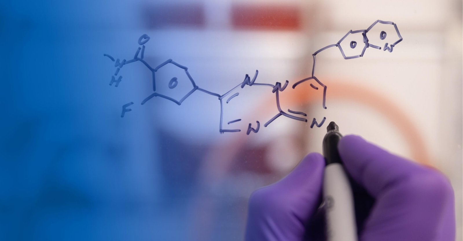Scientists drawing molecules on a white board