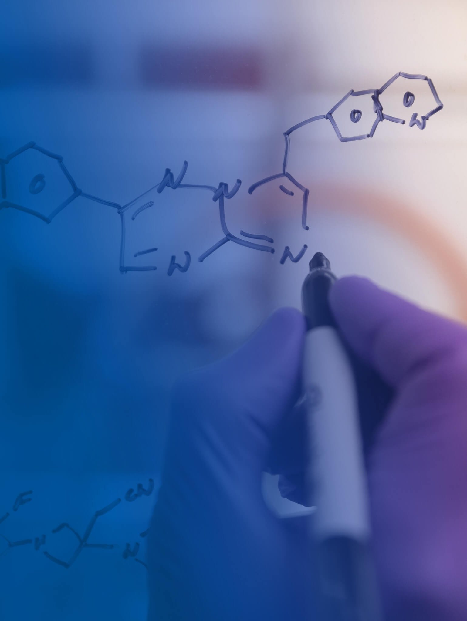 Scientists drawing molecules on a white board