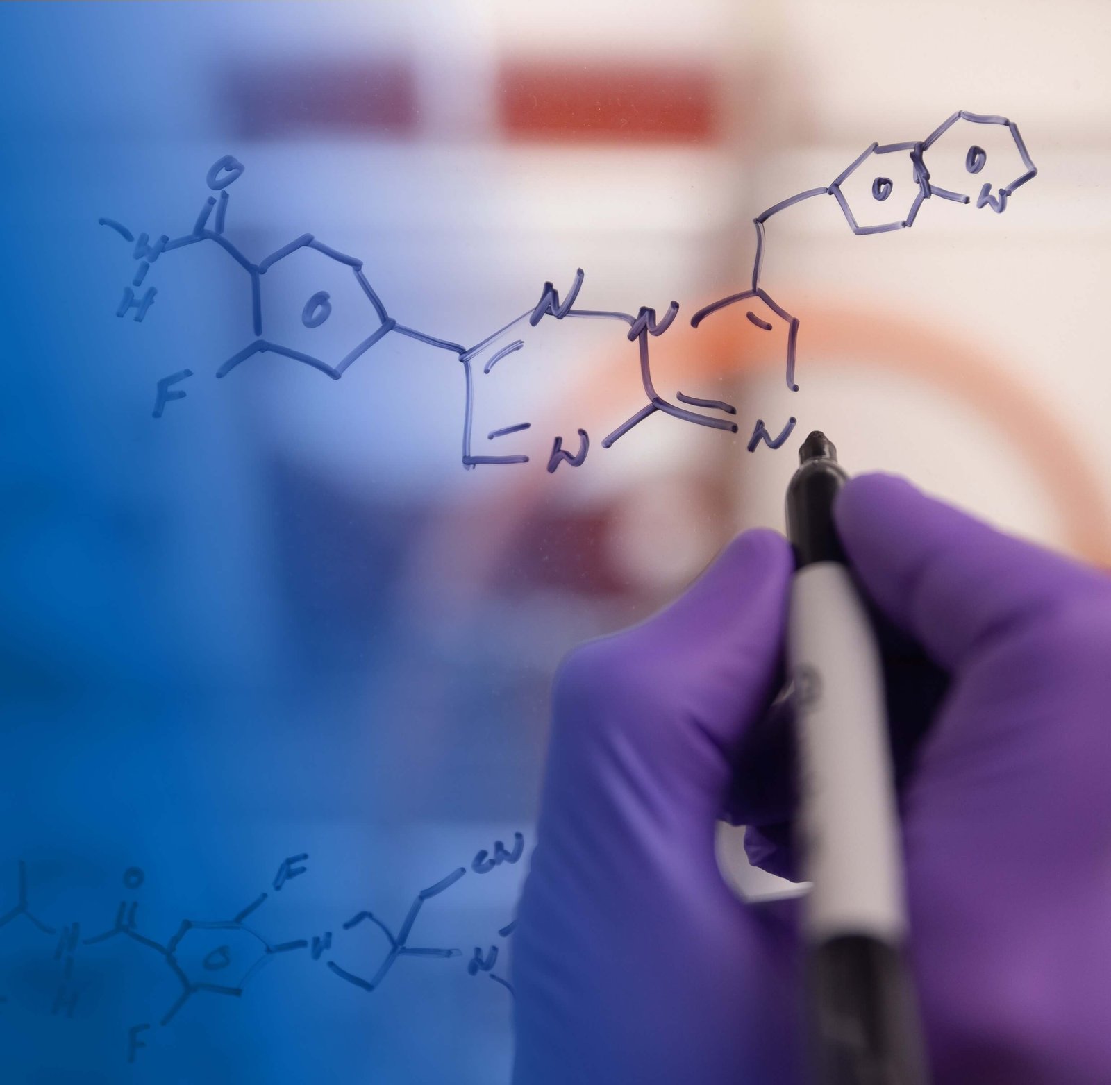 Scientists drawing molecules on a white board