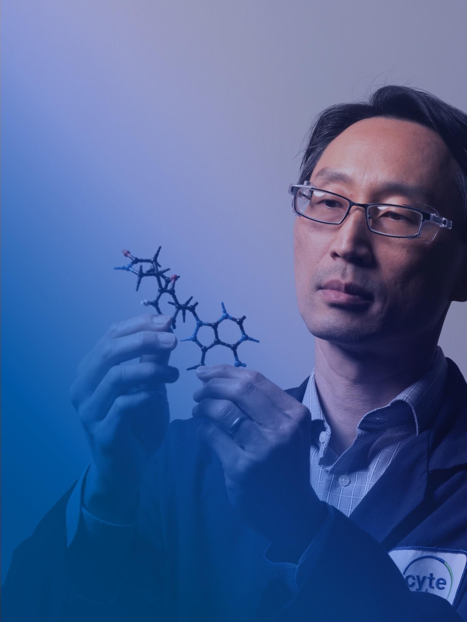 Scientist looking at a molecule model