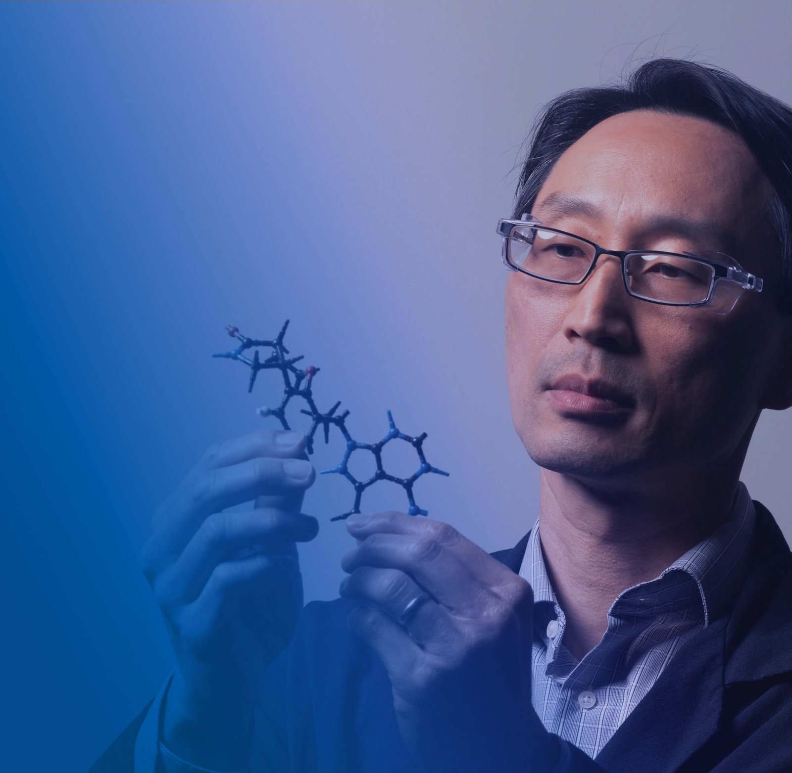 Scientist looking at a molecule model