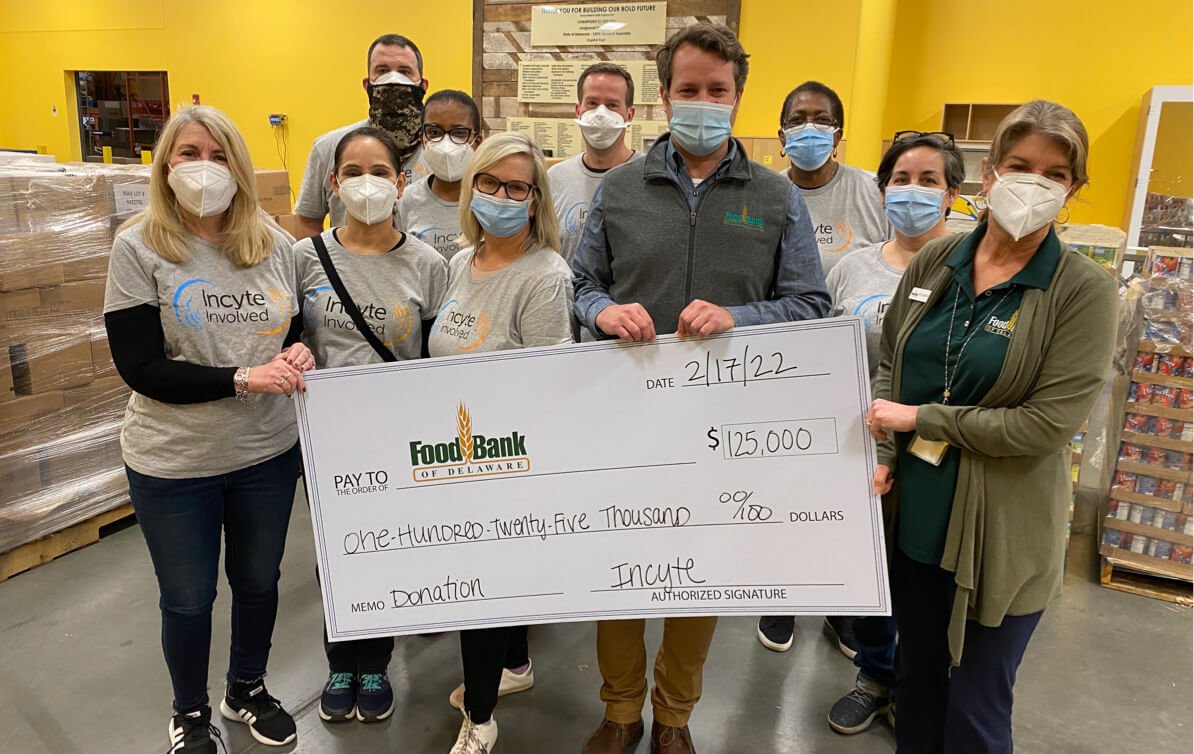 Group of people presenting Food Bank check